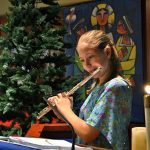 A student making music at Christmas